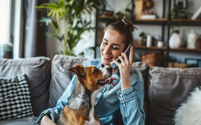 Dog owner on the phone with a veterinarian