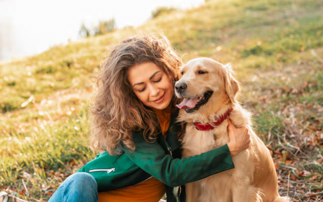 A woman hugging her English Golden Retriever